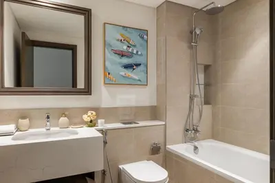 a bathroom with a sink and a toilet and a mirror at Ultimate Beachfront family home with panoram views! in Dubai