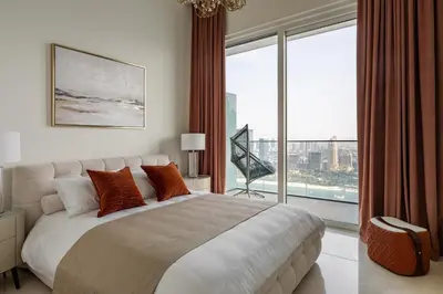 a bedroom with a large bed and a large window at Ultimate Beachfront family home with panoram views! in Dubai