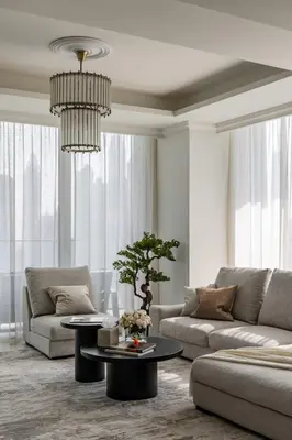 a living room with a couch and a table and a chandelier at Ultimate Beachfront family home with panoram views! in Dubai