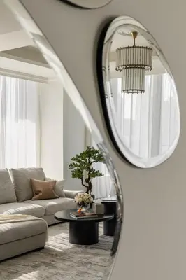 a living room with a couch and a round mirror at Ultimate Beachfront family home with panoram views! in Dubai