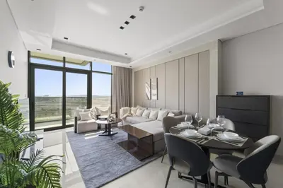 a living room with a couch and a table and chairs at Modern 2BR at Nobles Tower Near Downtown in Dubai