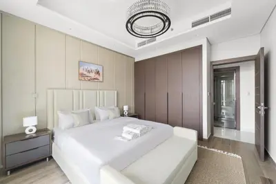 a large white bedroom with a large white bed at Modern 2BR at Nobles Tower Near Downtown in Dubai