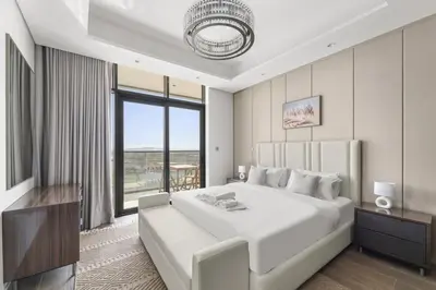 a bedroom with a large white bed and a large window at Modern 2BR at Nobles Tower Near Downtown in Dubai