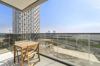 a balcony with a table and a view of a city at Modern 2BR at Nobles Tower Near Downtown in Dubai