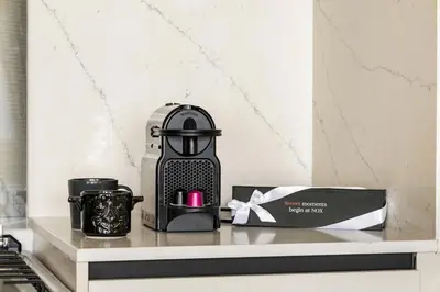 a coffee maker on a shelf next to a box at Stylish 1BR Retreat Near World Trade Center Metro in Dubai