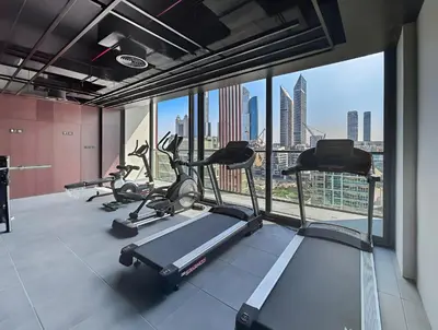 a gym with a view of a city skyline at Stylish 1BR Retreat Near World Trade Center Metro in Dubai