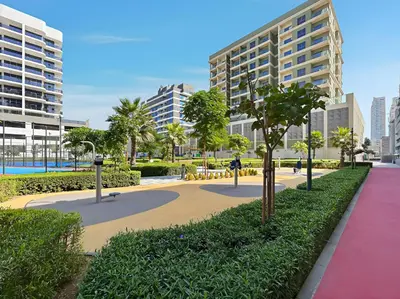 a walkway in a city with trees and buildings at Stylish 1BR Retreat Near World Trade Center Metro in Dubai