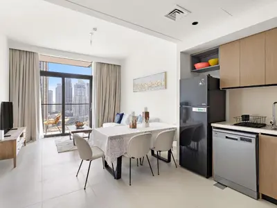 a kitchen and dining room with a table and chairs at Breathtaking 1 BDR w Partial Burjkhalifa View in Dubai