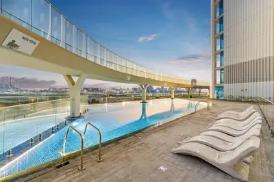 a large swimming pool on the top of a building at Modern Studio on 27th Floor with Miracle Garden Views in Dubai