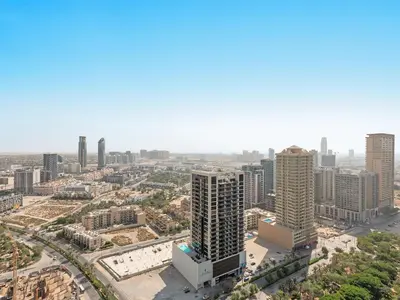 an aerial view of a city with tall buildings at Spacious Studio w Sofa Bed Sleeps 4 in JVC in Dubai