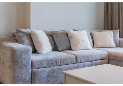 a couch with pillows on it in a living room at Aspin Brand New Cozy 1BR at Binghatti Lavender JVC in Dubai