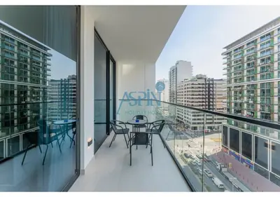 a balcony with a table and chairs on it at Aspin Brand New Cozy 1BR at Binghatti Lavender JVC in Dubai