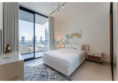 a white bedroom with a bed and a large window at Aspin Brand New Cozy 1BR at Binghatti Lavender JVC in Dubai