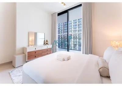 a bedroom with a white bed with a large window at Aspin Brand New Cozy 1BR at Binghatti Lavender JVC in Dubai