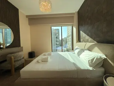 a bedroom with a large bed and a window at Luxury 2BR in Creek Beach with Lagoon Access in Dubai