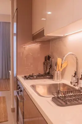 a kitchen with a sink and a counter top at Cosy Modern Studio Downtown Dubai in Dubai