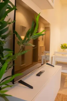 a living room with a tv on a table at Cosy Modern Studio Downtown Dubai in Dubai