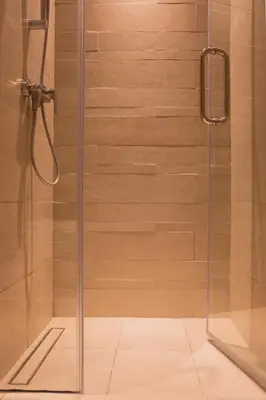 a shower with a glass door in a bathroom at Cosy Modern Studio Downtown Dubai in Dubai