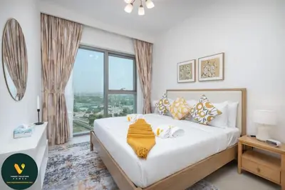 a bedroom with a large bed with a large window at Vogue Downtown Views II with Direct Access to Dubai Mall Via a Climate Controlled Bridge, One Bedroom Apartment with Balcony and City View in Dubai