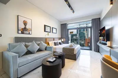 a living room with a couch and a bed at Luxury Canal View Studio for 4 Guests in Downtown, 5 Min to Dubai Mall in Dubai