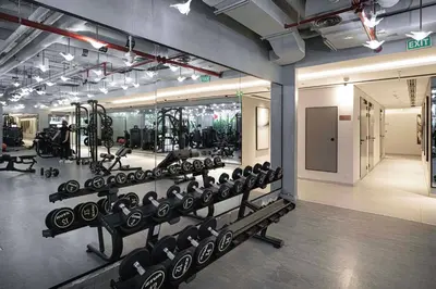 a gym with rows of dumbbells and weights at Luxury Canal View Studio for 4 Guests in Downtown, 5 Min to Dubai Mall in Dubai