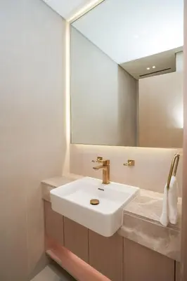 a bathroom with a sink and a mirror at Bright 1-Bed with Pool and Gym in Dubai