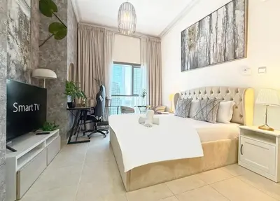 a bedroom with a large bed and a television at Studio in Dubai Marina near by Beach & Metro Z1409 in Dubai