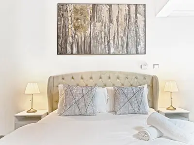 a bedroom with a white bed with two lamps at Studio in Dubai Marina near by Beach & Metro Z1409 in Dubai