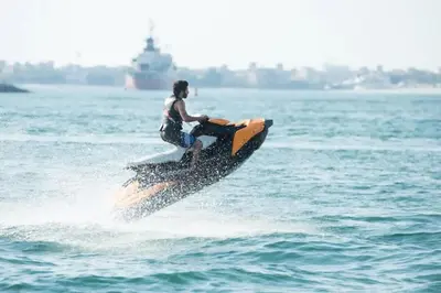 a man on a jet ski in the water at OneBedroom Apartment with Partial Sea view in Dubai Marina - Z1106 in Dubai
