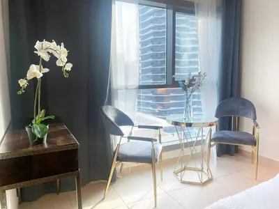 a room with two chairs and a table and a window at Studio - Dubai Marina - Partial Marina View Z1104 in Dubai