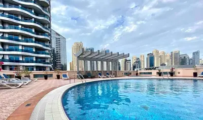 a large swimming pool with a city skyline in the background at Studio - Dubai Marina - Partial Marina View Z1104 in Dubai