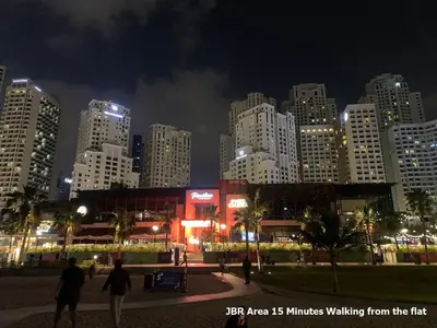 a city skyline at night with people walking around at Enjoy Studio in Dubai Marina - Partial Marina View in Dubai