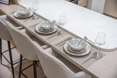 a table with plates and wine glasses on it at StayShort - Modern 1 Bedroom with Private Jacuzzi in JVC that Sleeps 2 in Dubai
