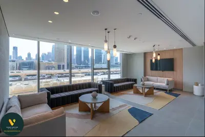 a large living room with couches and a large window at Vogue Downtown Views II with Direct Access to Dubai Mall Via a Climate Controlled Bridge, One Bedroom Apartment with Balcony and City View in Dubai
