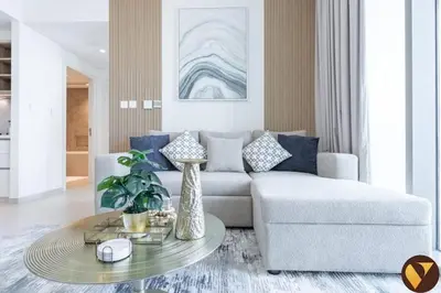 a living room with a couch and a table at Vogue Downtown Views II with Direct Access to Dubai Mall Via a Climate Controlled Bridge, One Bedroom Apartment with Balcony and City View in Dubai