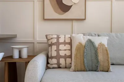 a couch with pillows on it in a living room at GuestReady - Luxe Stay with Private Pool in Dubai