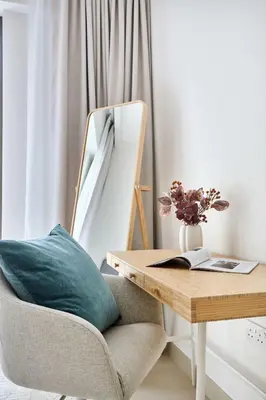 a desk and a chair with a pillow on it at Frank Porter - Grove at Creek Beach Building in Dubai