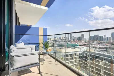 an apartment balcony with a view of a city at Frank Porter - Binghatti Corner in Dubai