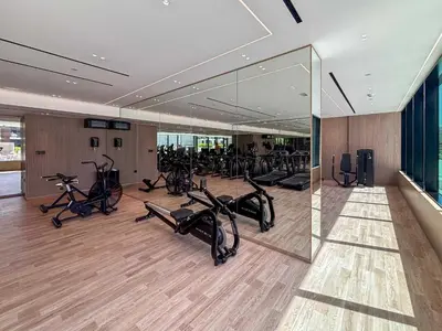 a gym with treadmills and exercise bikes in it at Frank Porter - Binghatti Corner in Dubai