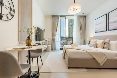 a bedroom with a bed and a table and a desk at Prime Location, Walking Distance to Circle Mall, Minutes Drive from Dubai Marina and Palm Jumeirah - Binghatti Aurora, JVC by Deluxe Holiday Homes in Dubai