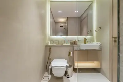 a bathroom with a toilet and a sink at Prime Location, Walking Distance to Circle Mall, Minutes Drive from Dubai Marina and Palm Jumeirah - Binghatti Aurora, JVC by Deluxe Holiday Homes in Dubai