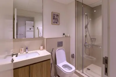 a bathroom with a toilet and a sink and a shower at Stunning Apartment - Downtown View 2 - Tower 1 - Fountain and Burj Khalifa view 61st floor in Dubai