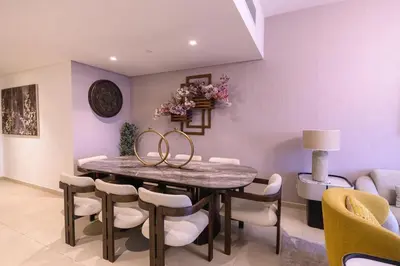 a dining room with purple walls and a table and chairs at Stunning Apartment - Downtown View 2 - Tower 1 - Fountain and Burj Khalifa view 61st floor in Dubai