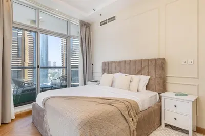 a bedroom with a large bed and a large window at Marina Escape Spacious Skyview 2BR in Dubai