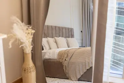 a bedroom with a bed and a mirror at Marina Escape Spacious Skyview 2BR in Dubai