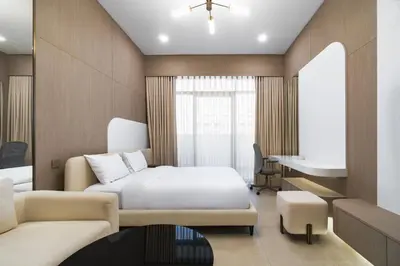 a hotel room with a bed and a desk at SettlerHomes - Chic JVC Studio - Pool & Clubhouse in Dubai