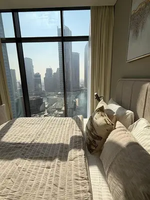 a bedroom with a bed and a large window at Luxurious view of the Business Bay canal, 2 beds in Dubai