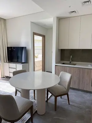 a kitchen with a table and chairs in a room at Luxurious view of the Business Bay canal, 2 beds in Dubai
