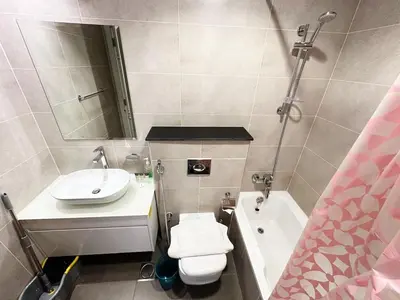 a bathroom with a sink and a toilet and a tub at Cozy Studio Retreat in Damac Hills in Dubai