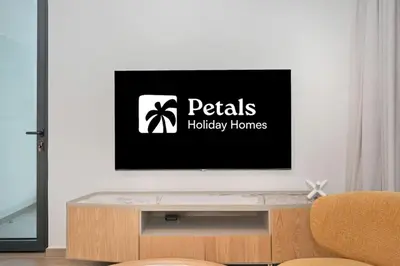 a living room with a flat screen tv on a wall at Belgravia Heights 1 BHK in JVC in Dubai